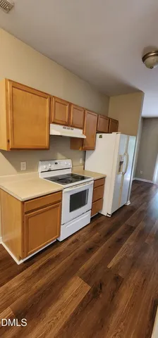 a kitchen with wooden floors and a stove