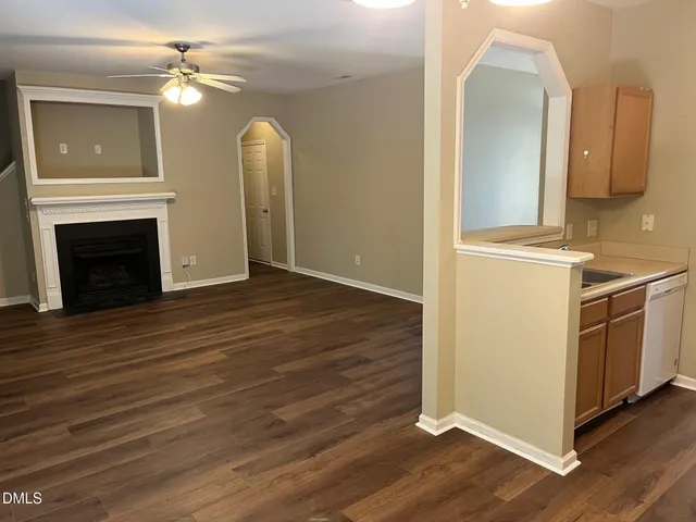 a view of a kitchen with a sink and a fireplace
