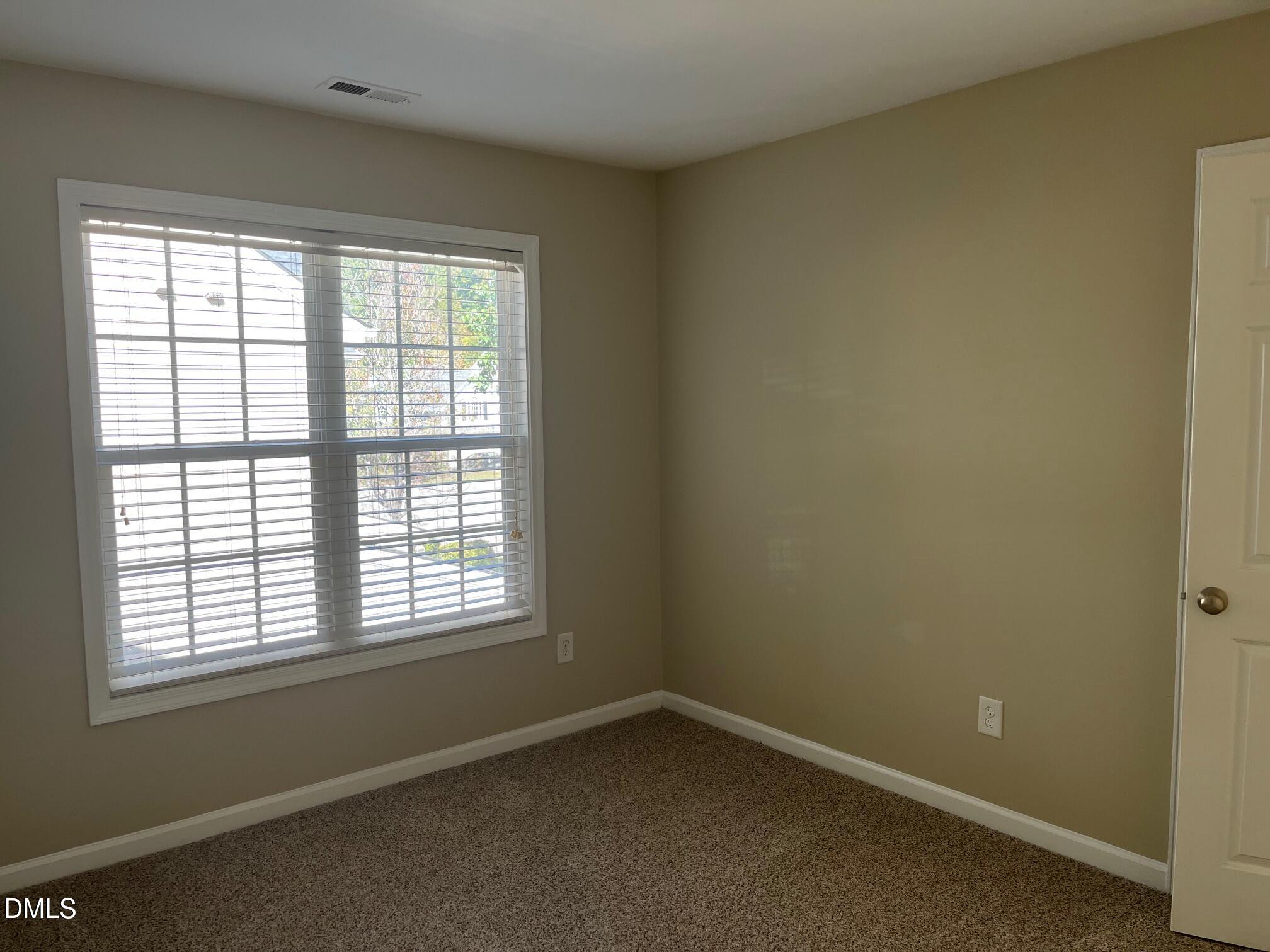 8165 Rolling Glenn Drive Raleigh, NC 27616 - Photo 8 of 14 an empty room with a window