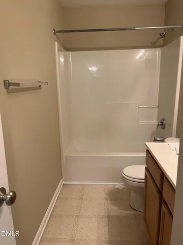 a bathroom with a shower a toilet and sink