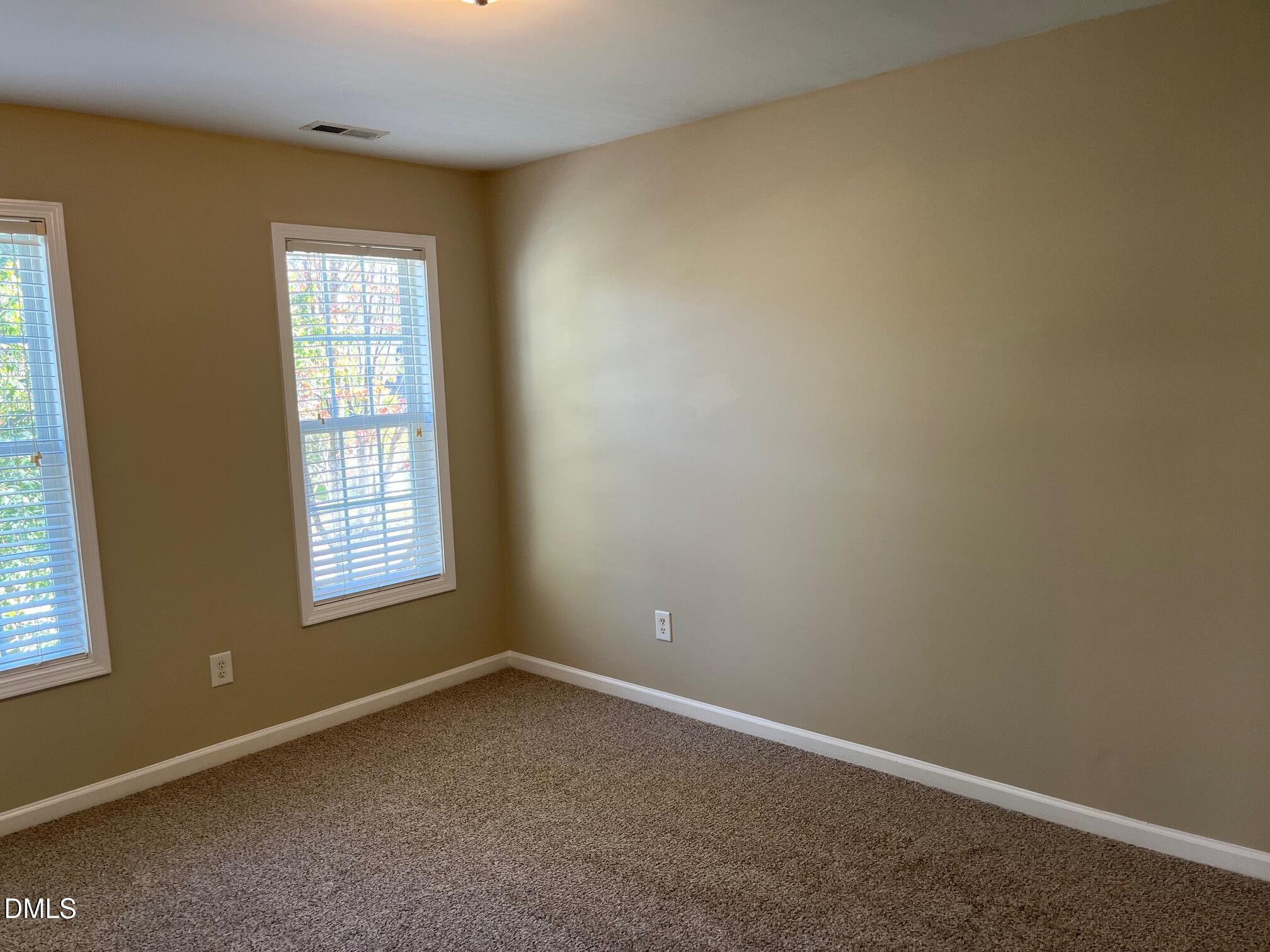 8165 Rolling Glenn Drive Raleigh, NC 27616 - Photo 10 of 14 an empty room with a window