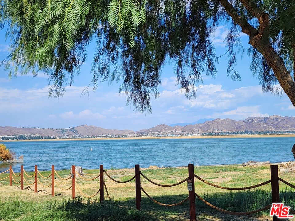 17650 Grand Avenue, Unit 102 Lake Elsinore, CA 92530 - Photo 1 of 1 a view of swimming pool with seating area and trees around