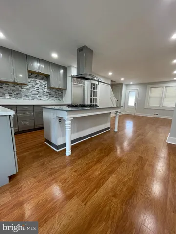 a view of kitchen with stainless steel appliances granite countertop a sink and cabinets