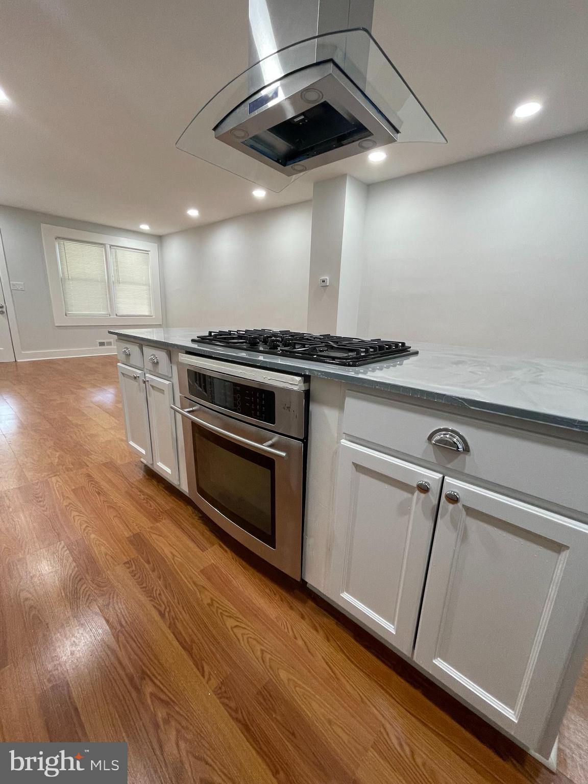 4540 Manorview Road Baltimore, MD 21229 - Photo 2 of 16 a view of a kitchen with a stove wooden floor and staircase