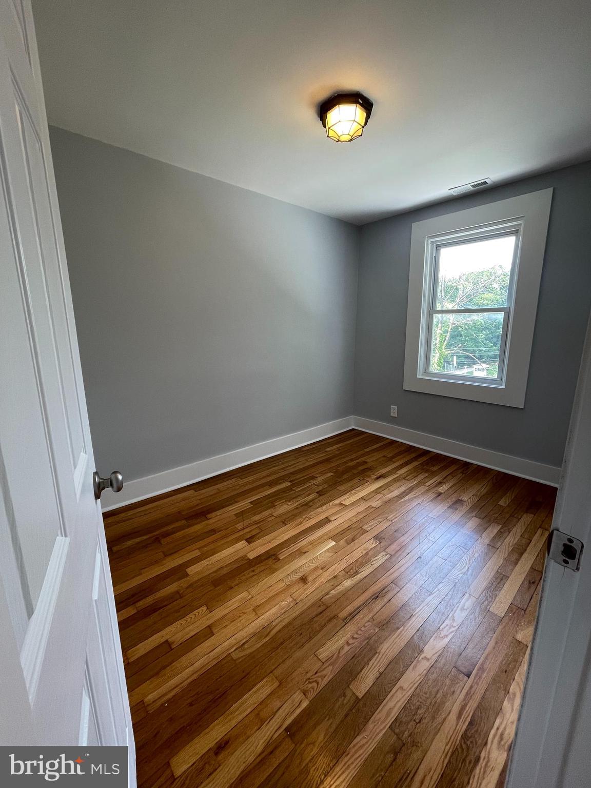 4540 Manorview Road Baltimore, MD 21229 - Photo 9 of 16 a view of room with window and hardwood floor