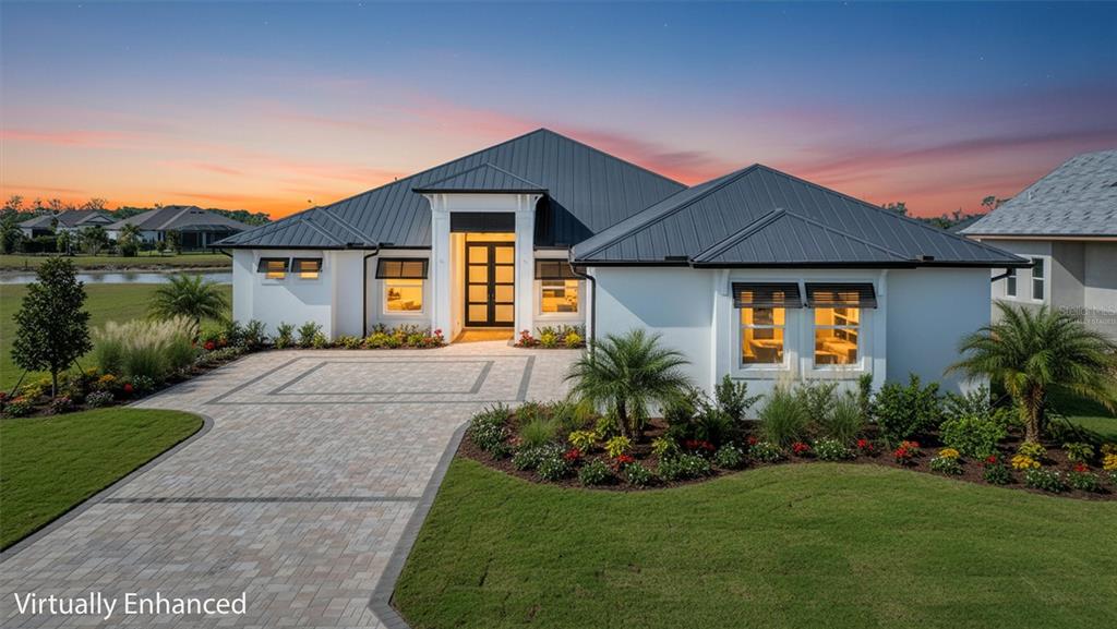 1613 148th Terrace East Parrish, FL 34219 - Photo 2 of 81 a front view of a house with a yard