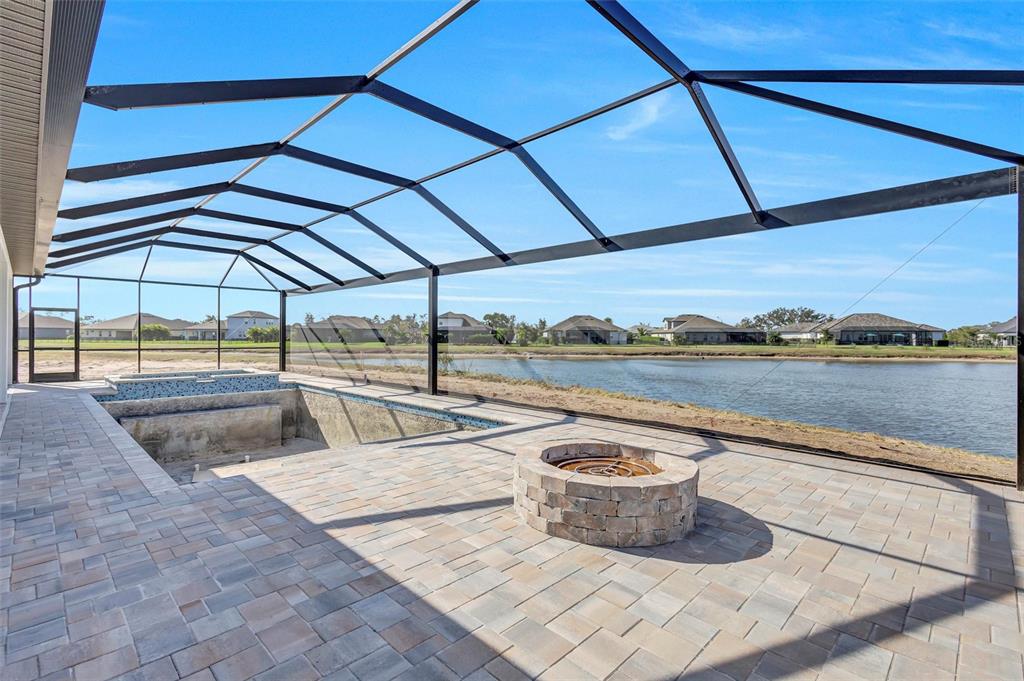 1613 148th Terrace East Parrish, FL 34219 - Photo 33 of 81 a view of a patio with a table and chairs under an umbrella
