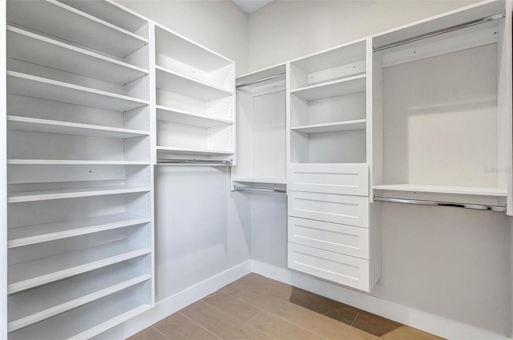 1613 148th Terrace East Parrish, FL 34219 - Photo 48 of 81 a view of walk in closet with empty racks