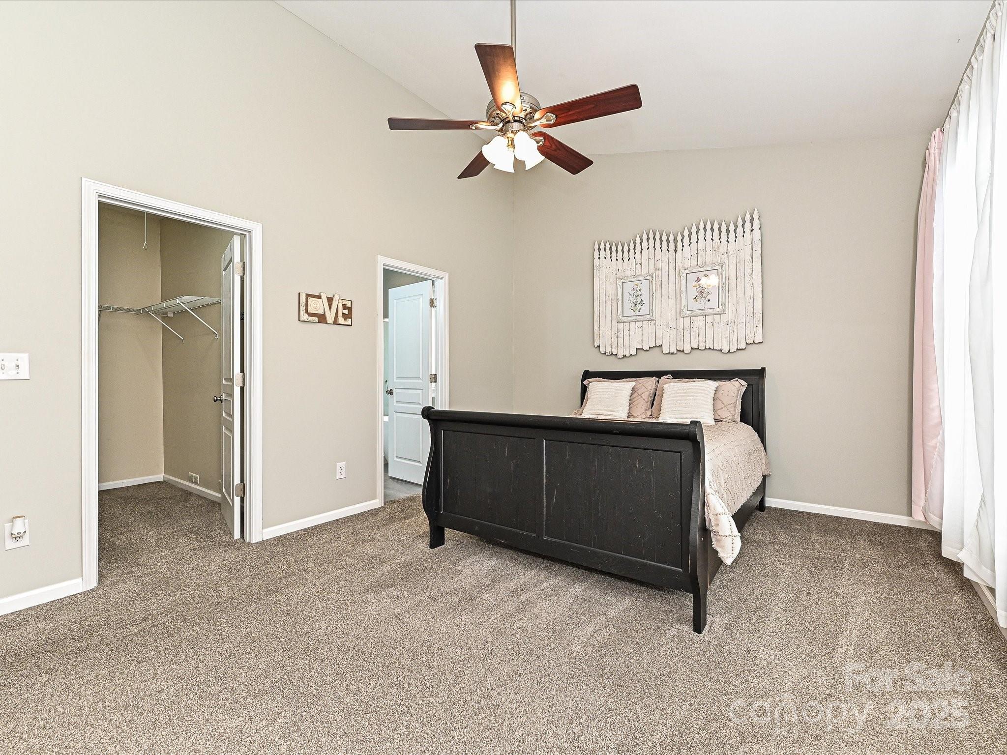 460 Silver Cypress Lane Fort Mill, SC 29708 - Photo 14 of 29 a living room with a bed and a ceiling fan