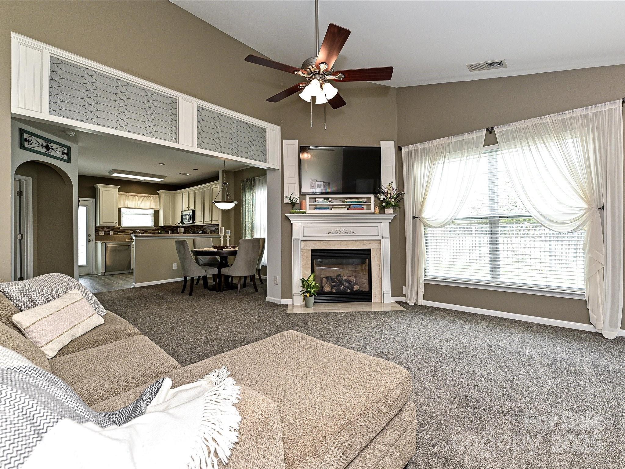 460 Silver Cypress Lane Fort Mill, SC 29708 - Photo 5 of 29 a living room with furniture fireplace and flat screen tv