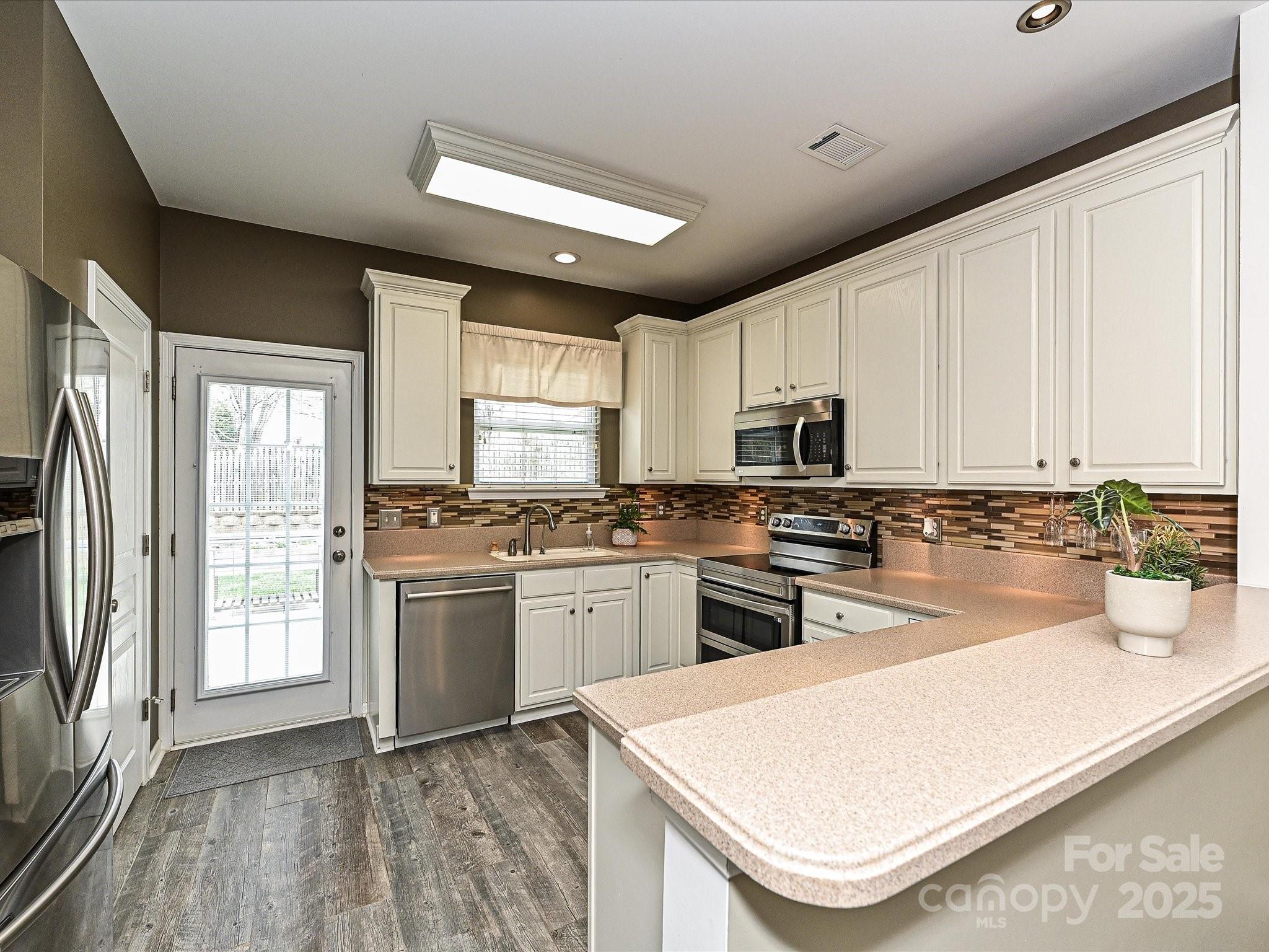 460 Silver Cypress Lane Fort Mill, SC 29708 - Photo 7 of 29 a kitchen with stainless steel appliances granite countertop a stove a sink dishwasher and a refrigerator