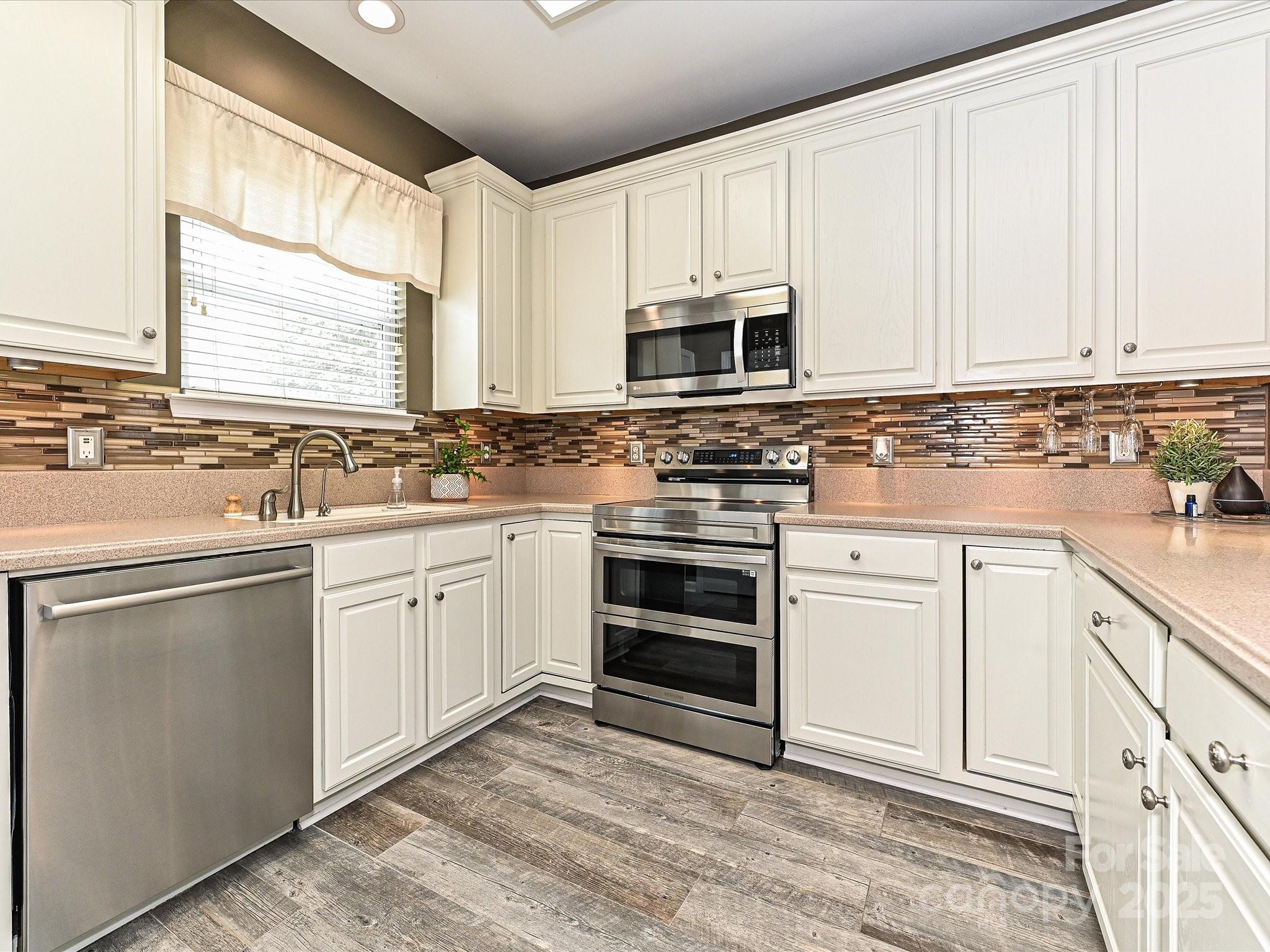460 Silver Cypress Lane Fort Mill, SC 29708 - Photo 8 of 29 a kitchen with stainless steel appliances granite countertop a sink stove and cabinets