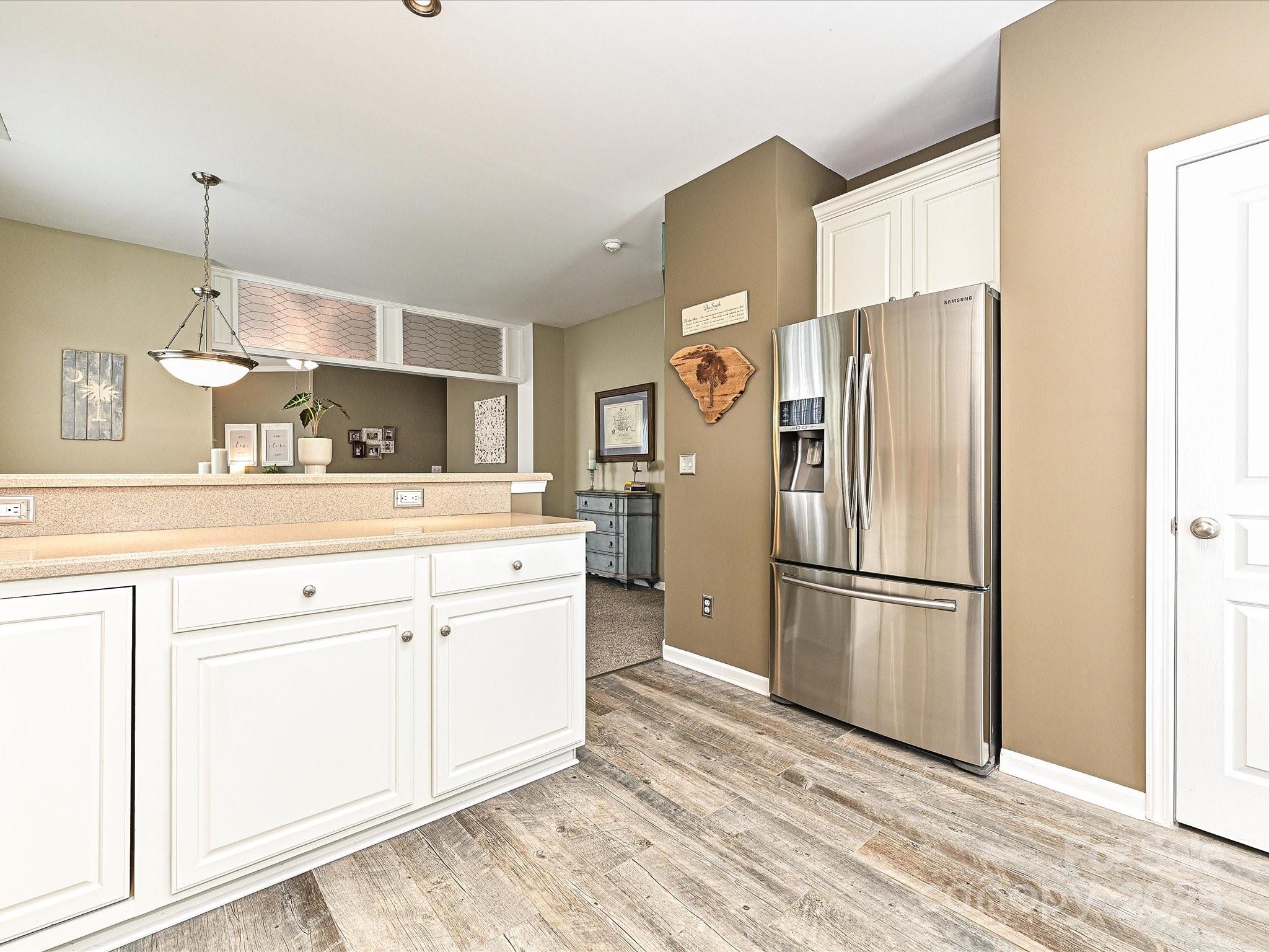 460 Silver Cypress Lane Fort Mill, SC 29708 - Photo 9 of 29 a kitchen with stainless steel appliances a refrigerator sink and cabinets