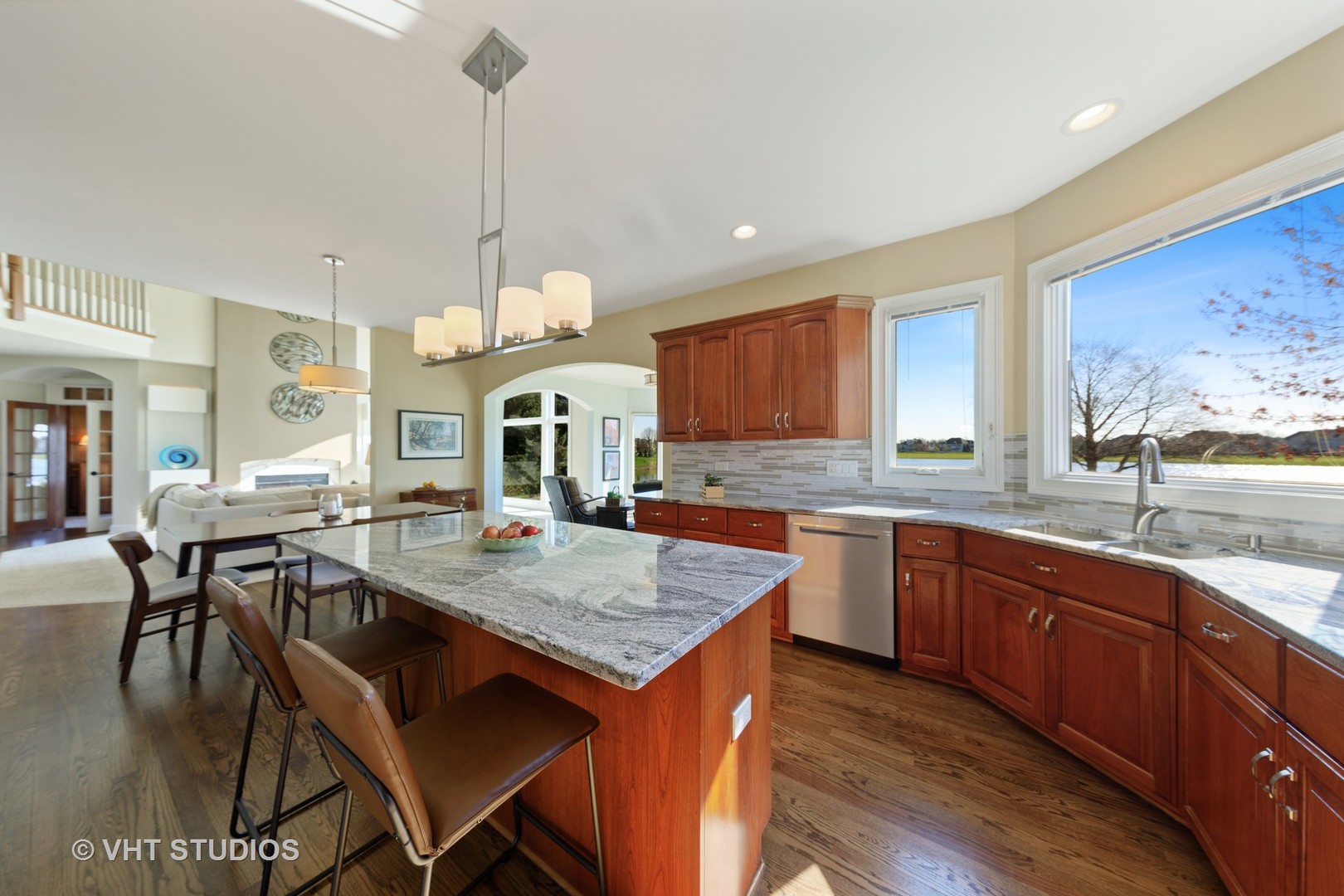 3651 White Eagle Drive Naperville, IL 60564 - Photo 11 of 47 a kitchen with a stove a sink a dining table and chairs