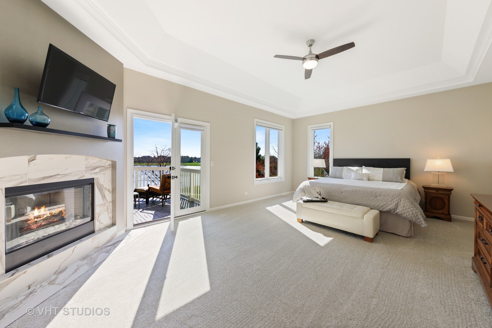 3651 White Eagle Drive Naperville, IL 60564 - Photo 19 of 47 a spacious bedroom with a bed a fireplace and a television