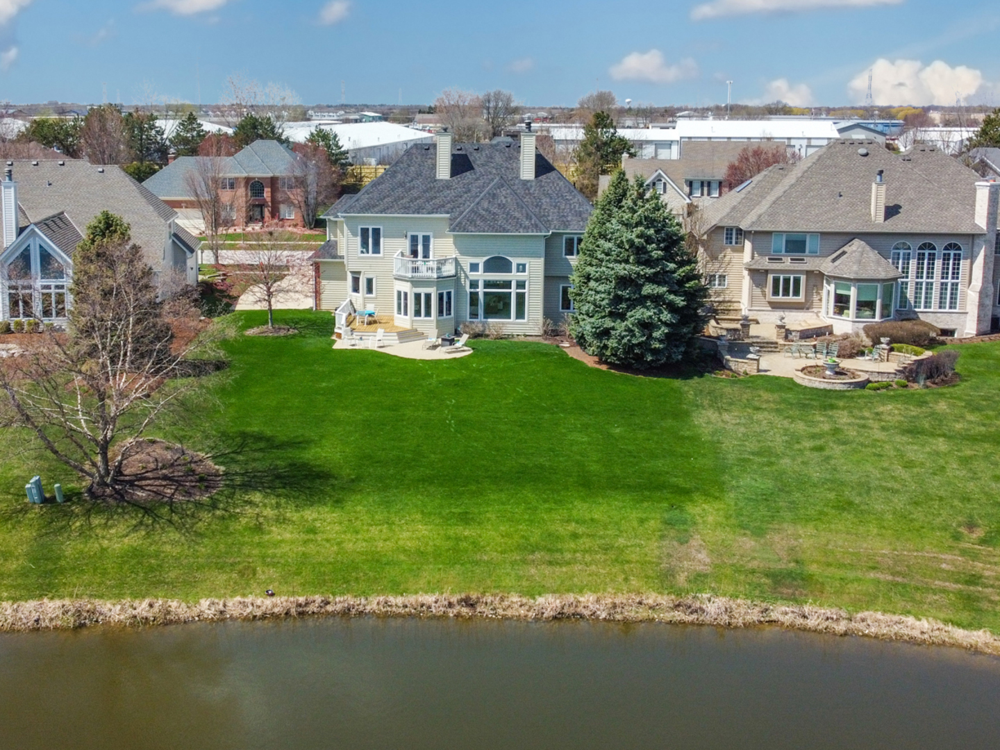 3651 White Eagle Drive Naperville, IL 60564 - Photo 40 of 47 a front view of a house with a garden and lake view