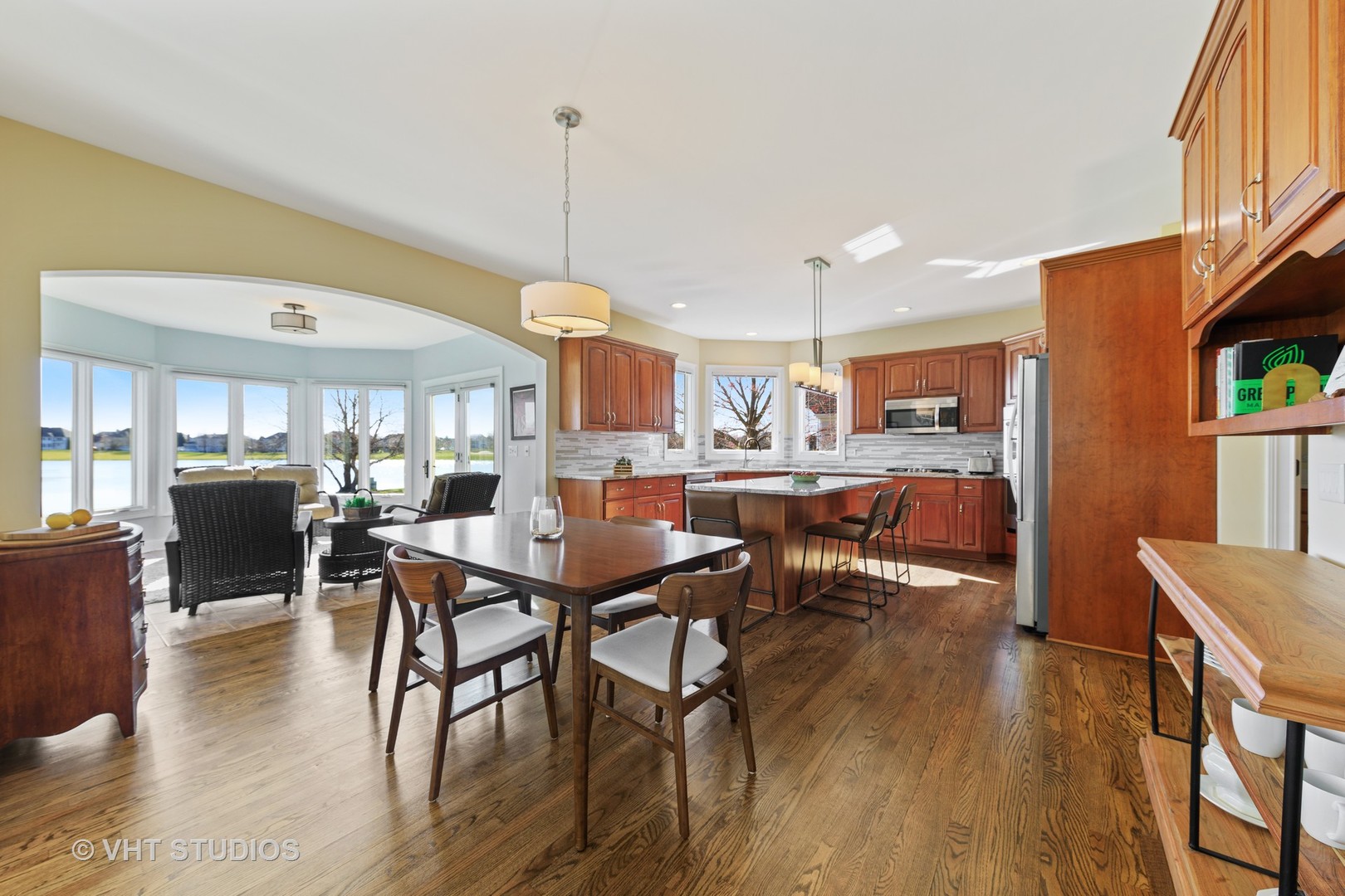 3651 White Eagle Drive Naperville, IL 60564 - Photo 7 of 47 a view of a dining room and livingroom with furniture wooden floor a rug a painting