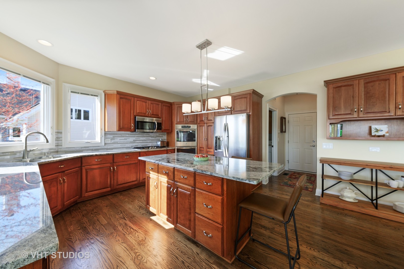 3651 White Eagle Drive Naperville, IL 60564 - Photo 8 of 47 a large kitchen with stainless steel appliances granite countertop a sink dishwasher a stove and a dining table with wooden floor