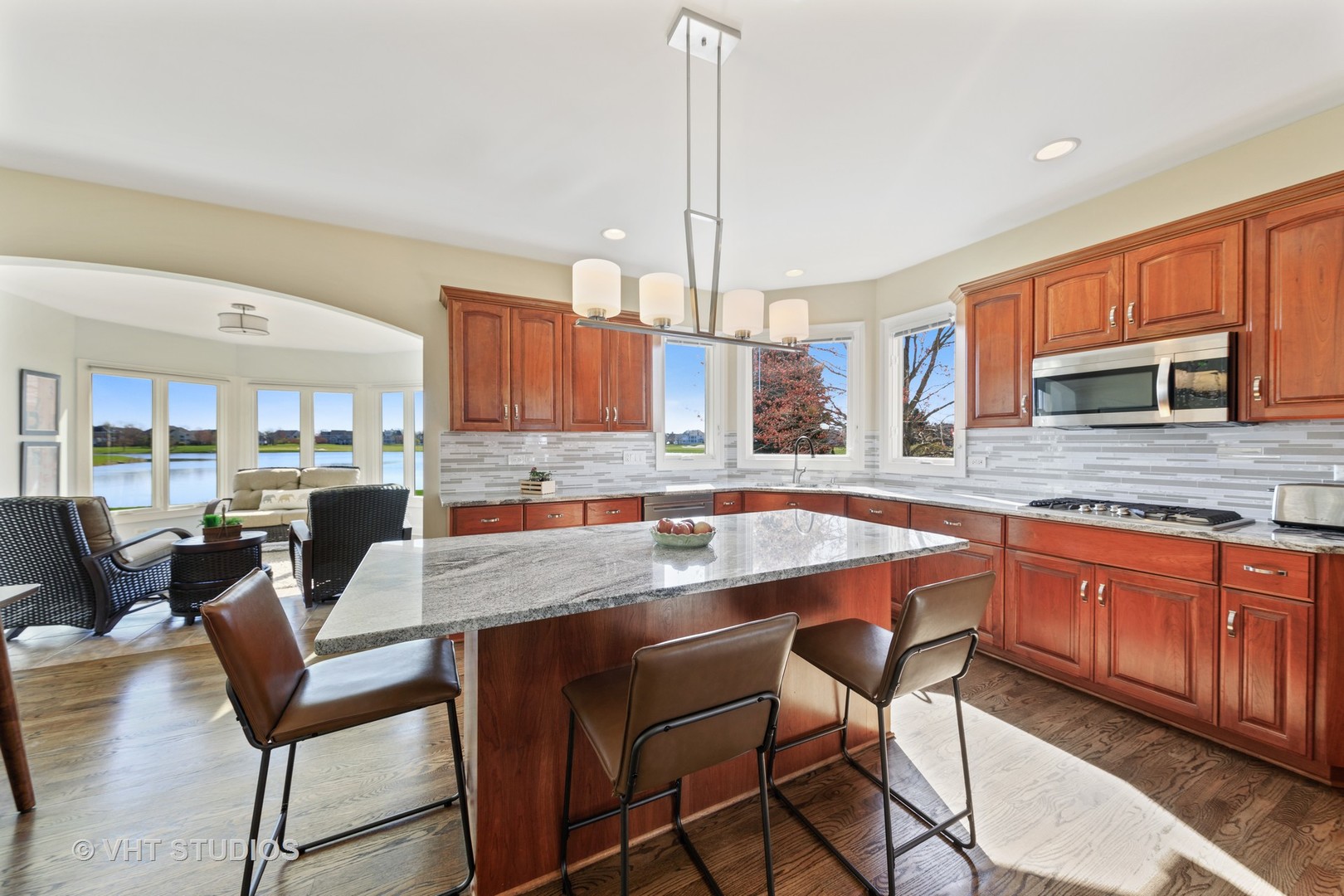 3651 White Eagle Drive Naperville, IL 60564 - Photo 9 of 47 a kitchen with stainless steel appliances granite countertop a table chairs and a sink