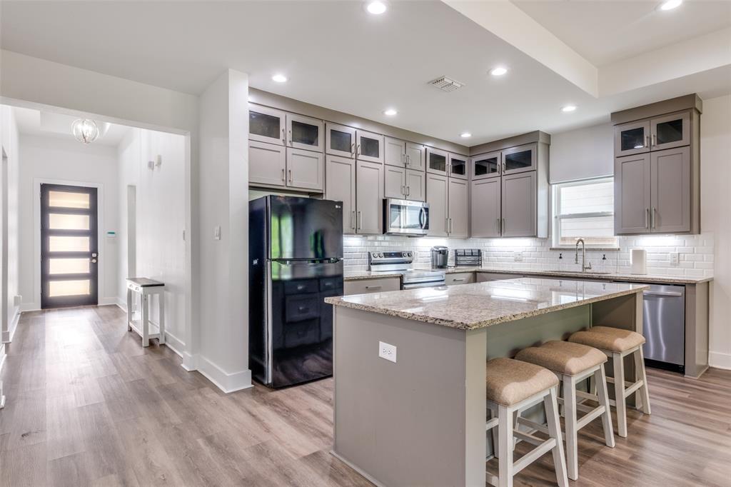 519 High Street Dallas, TX 75203 - Photo 5 of 13 a kitchen with kitchen island granite countertop a sink and refrigerator