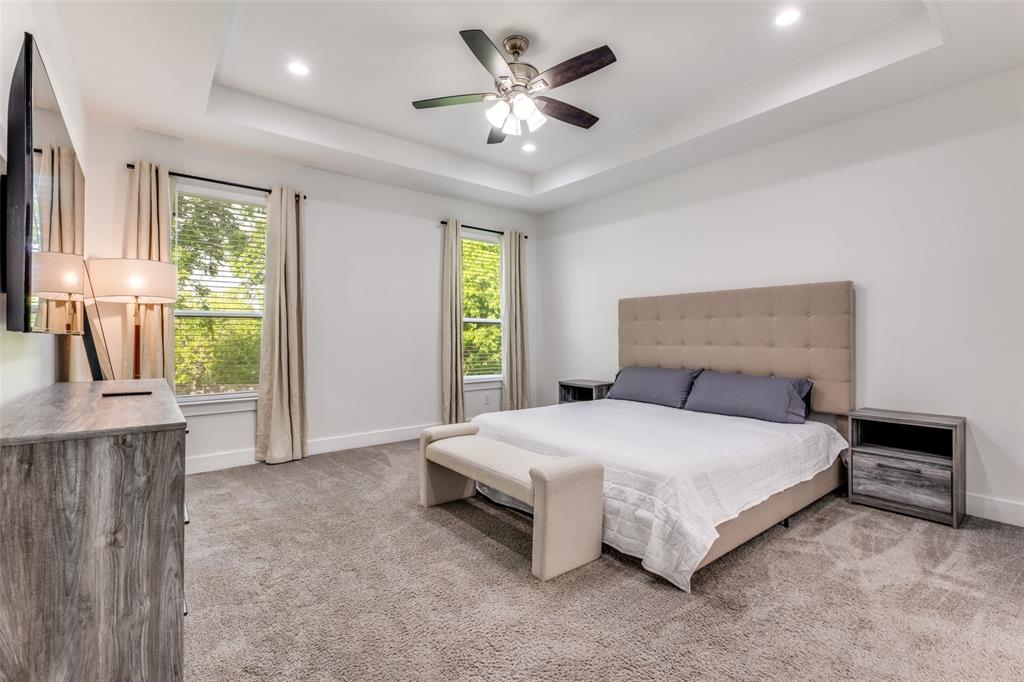 519 High Street Dallas, TX 75203 - Photo 6 of 13 a bedroom with a bed and a chandelier