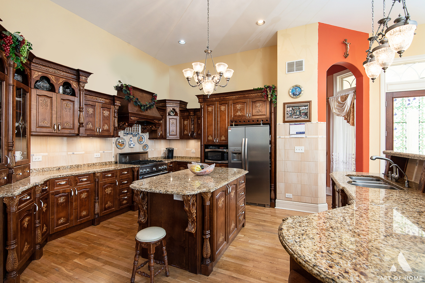 14940 El Greco Street Lemont, IL 60439 - Photo 17 of 67 a large kitchen with stainless steel appliances granite countertop a stove a refrigerator a sink dishwasher a dining table and chairs with wooden floor