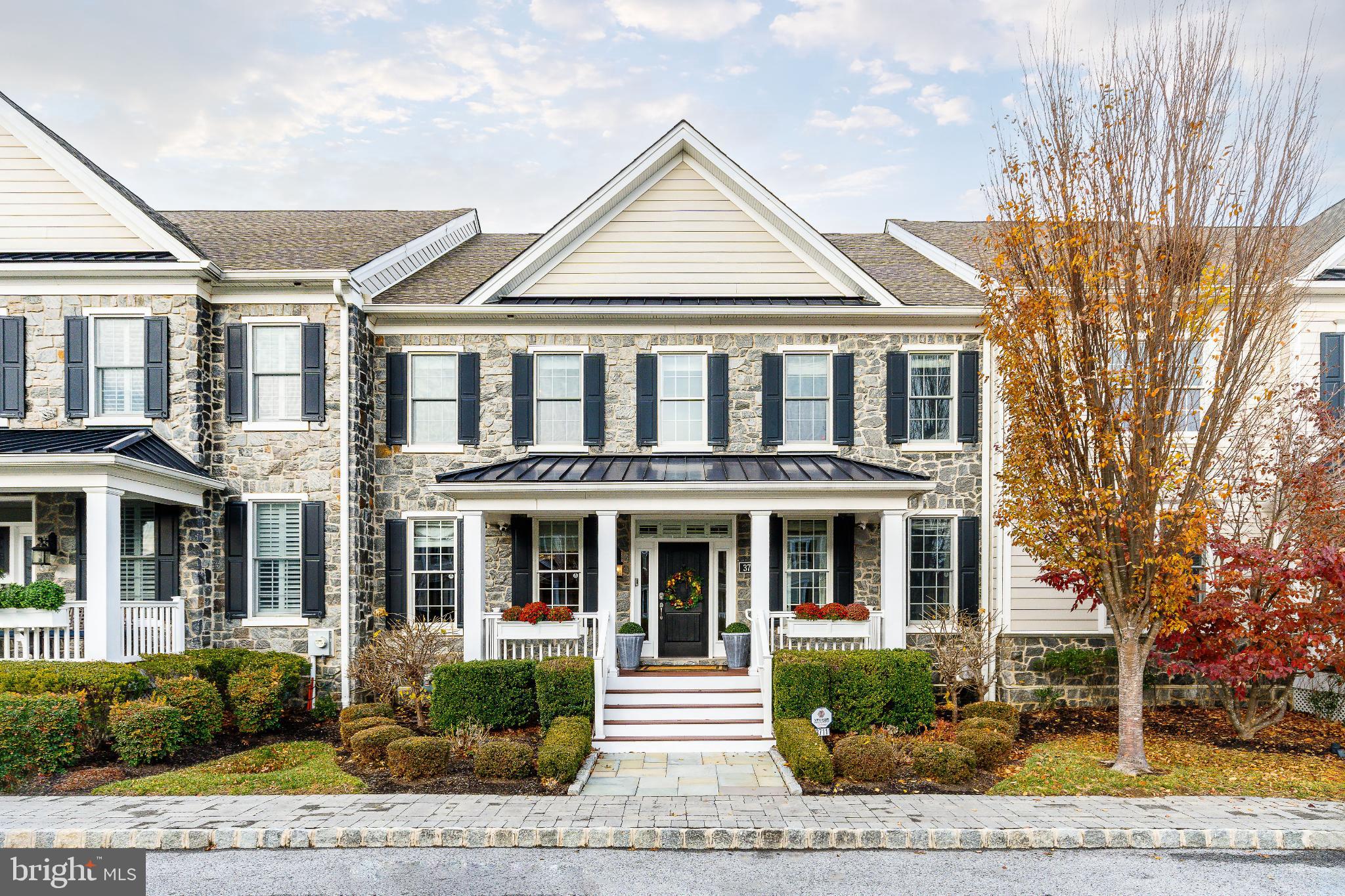 a front view of a residential apartment building with a yard