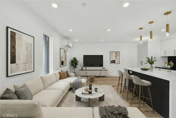 a living room with furniture a large window and a flat screen tv