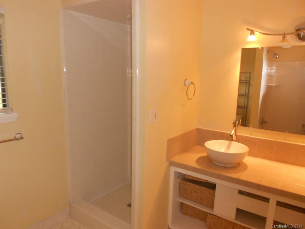 4135 Randolph Road, Unit 4 Charlotte, NC 28211 - Photo 13 of 22 a bathroom with a sink and a mirror