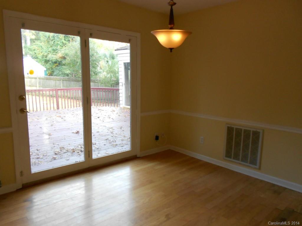 4135 Randolph Road, Unit 4 Charlotte, NC 28211 - Photo 6 of 22 a view of an empty room with wooden floor and a window