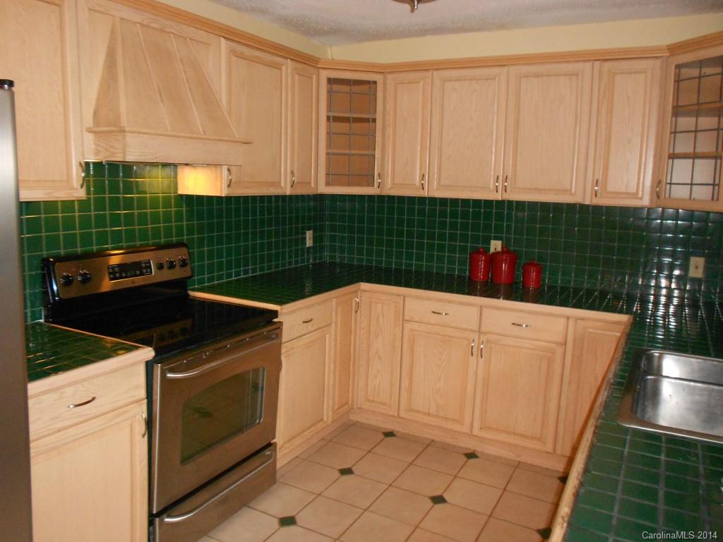 4135 Randolph Road, Unit 4 Charlotte, NC 28211 - Photo 9 of 22 a kitchen with a stove and cabinets