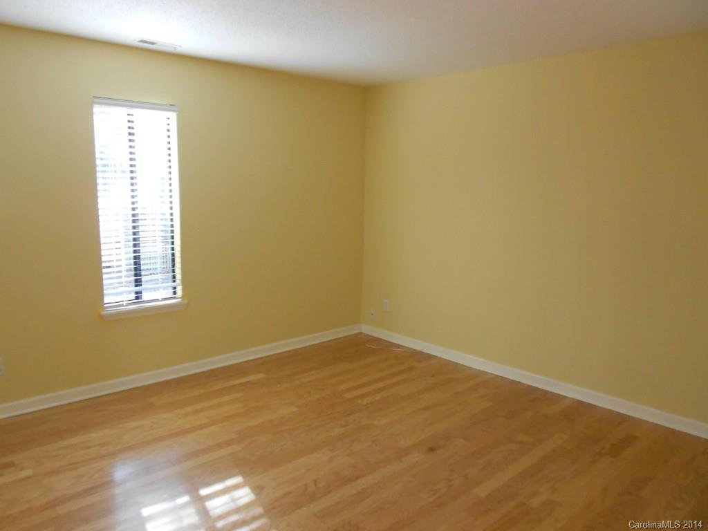 4135 Randolph Road, Unit 4 Charlotte, NC 28211 - Photo 10 of 22 a view of an empty room with wooden floor and a window