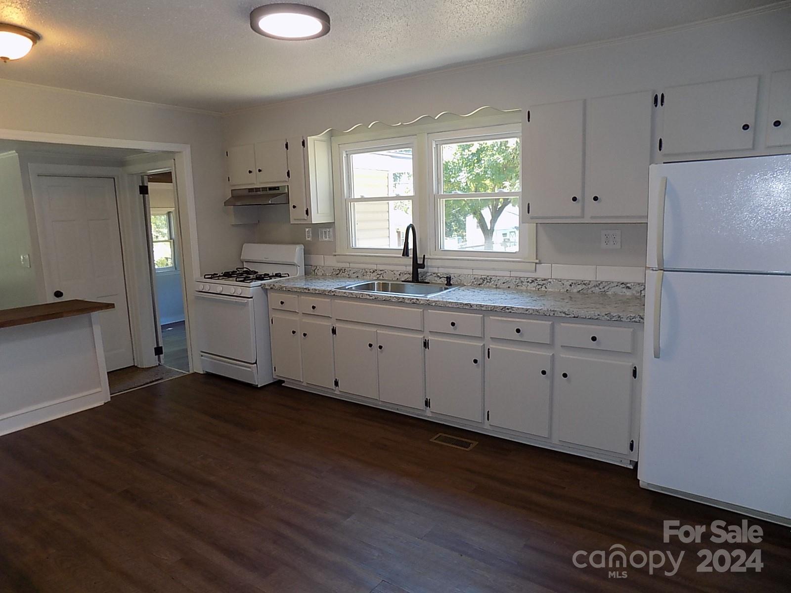 2435 Davis Park Road Gastonia, NC 28052 - Photo 3 of 10 a kitchen with a sink cabinets and wooden floor