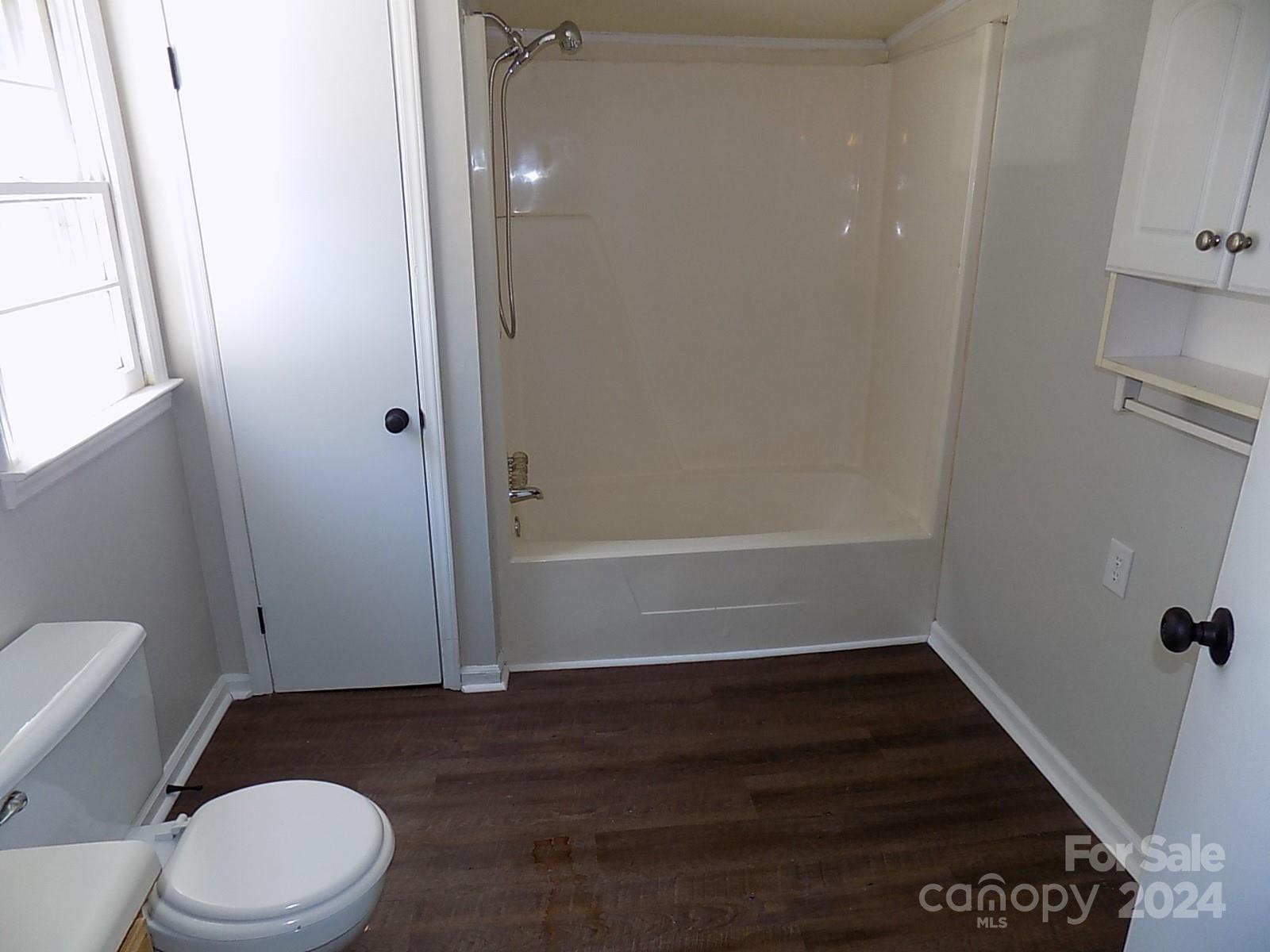 2435 Davis Park Road Gastonia, NC 28052 - Photo 9 of 10 a bathroom with a toilet and a wooden floor