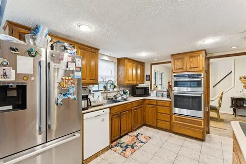 a kitchen with a sink refrigerator and cabinets