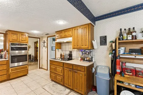 a kitchen with stainless steel appliances a stove sink and cabinets