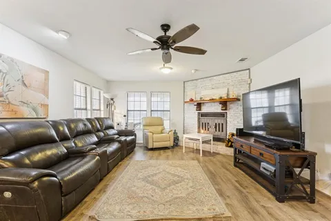 a living room with furniture a ceiling fan and a rug