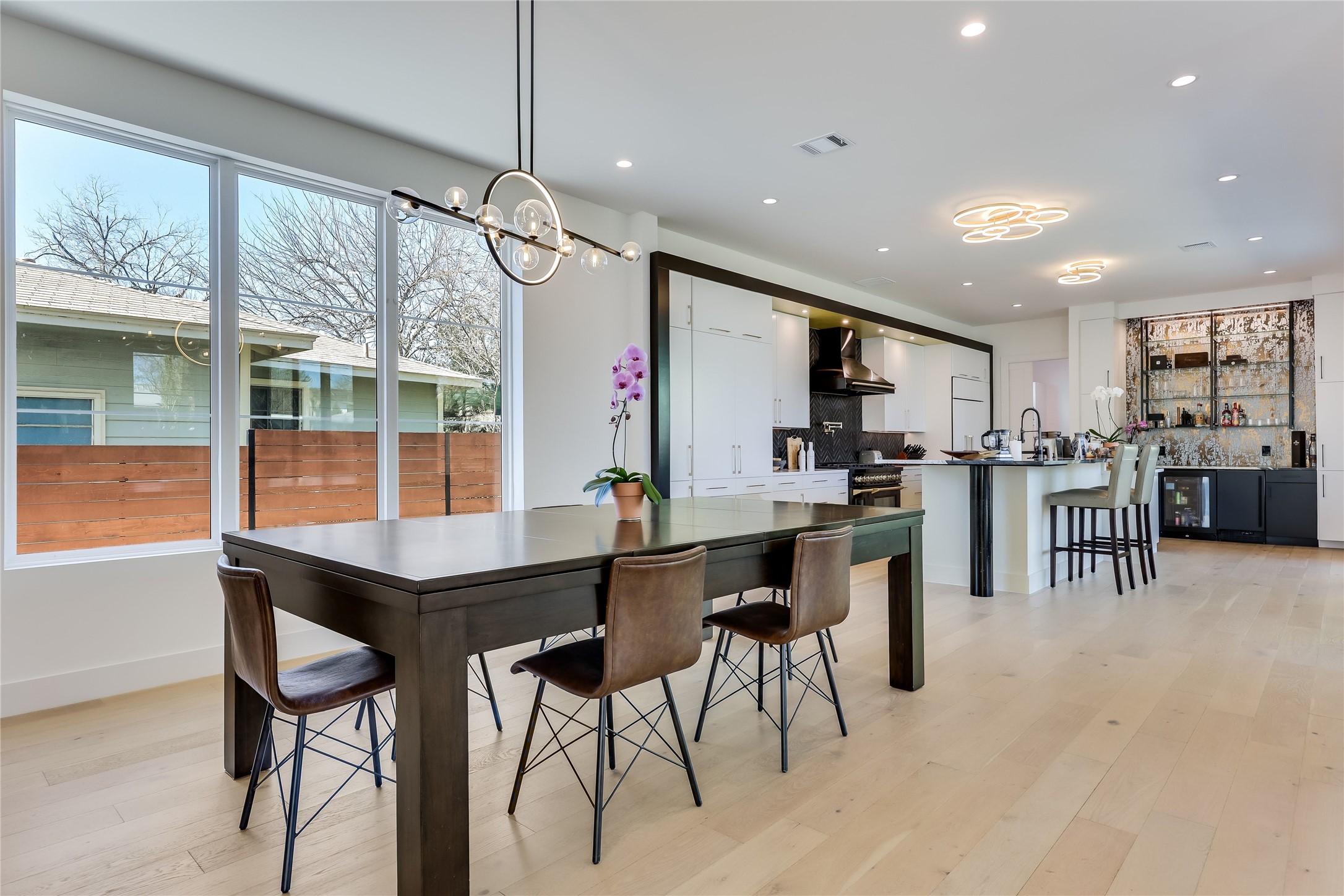 4600 Gillis Street Austin, TX 78745 - Photo 15 of 40 a kitchen with stainless steel appliances kitchen island granite countertop a table and chairs in it