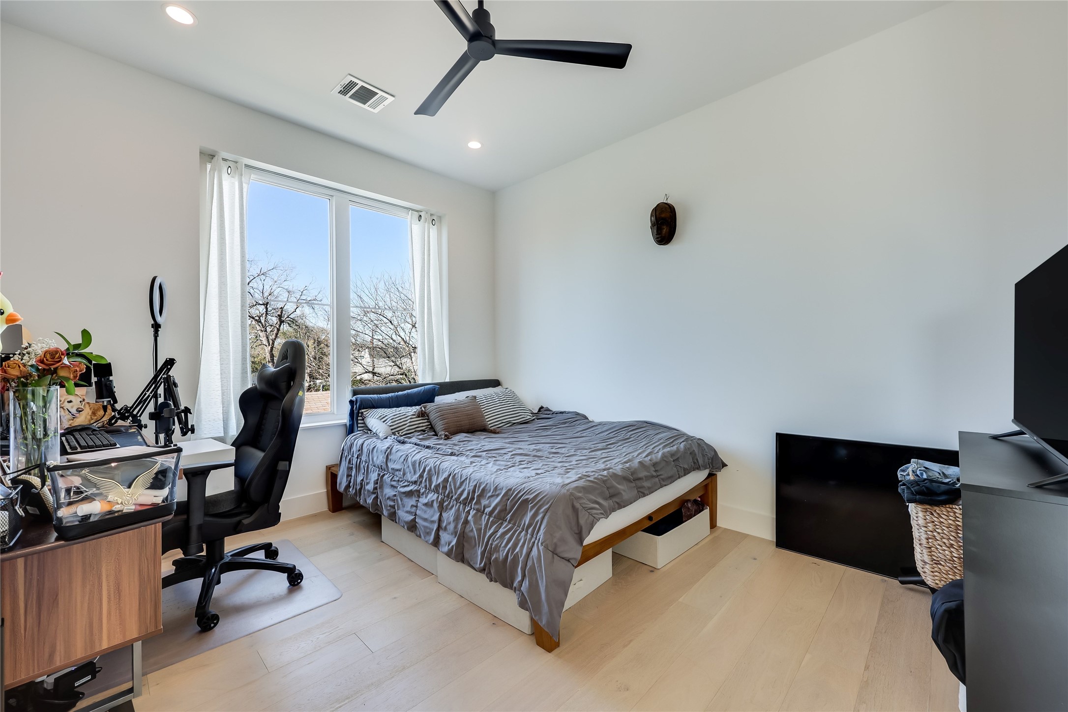 4600 Gillis Street Austin, TX 78745 - Photo 32 of 40 a bedroom with a bed window and a desk