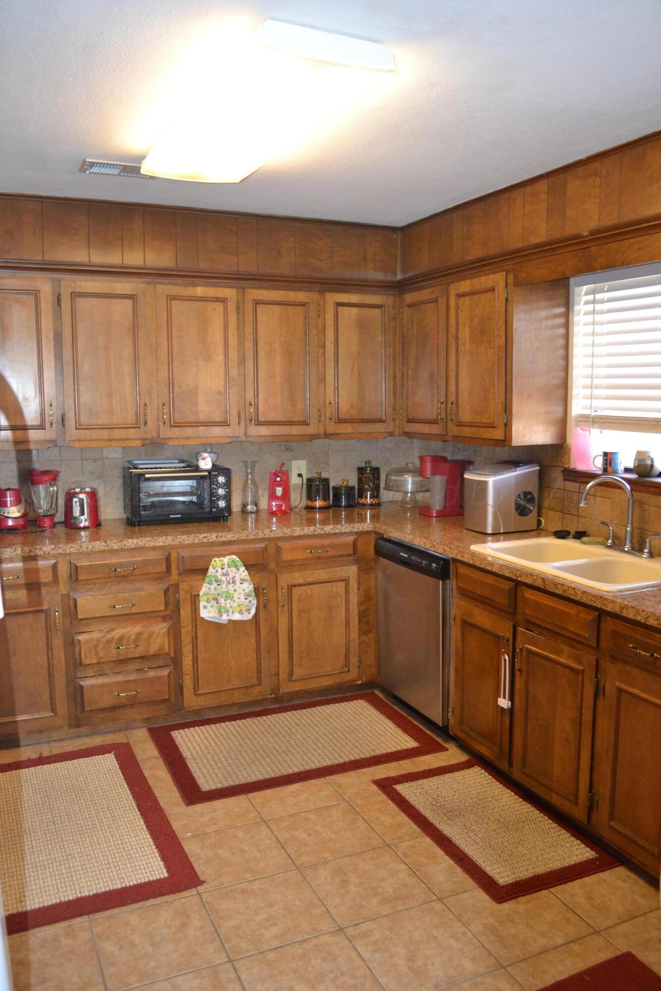 4307-4311 West 2nd Street Plainview, TX 79072 - Photo 13 of 51 a kitchen with stainless steel appliances granite countertop a sink window and cabinets