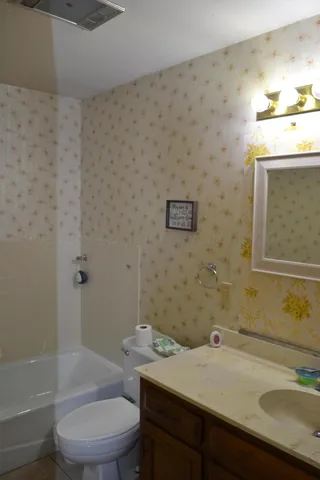 a bathroom with a sink toilet and shower