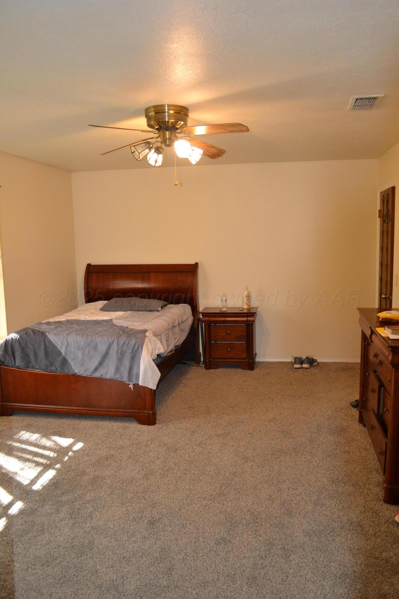 4307-4311 West 2nd Street Plainview, TX 79072 - Photo 19 of 51 a bedroom with a bed and a lamp with the screen