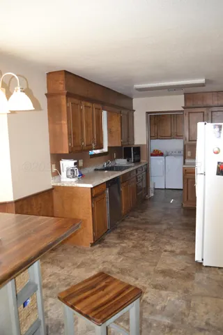 a kitchen with a stove a refrigerator and a sink