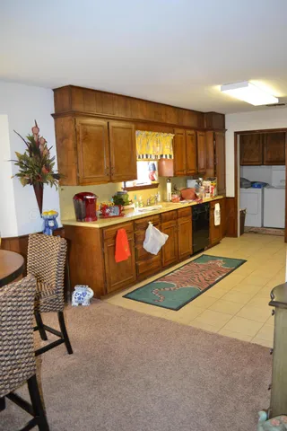 a kitchen with stainless steel appliances granite countertop sink stove and white cabinets