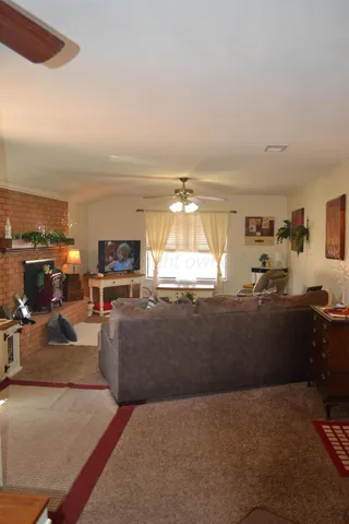 a living room with furniture and a kitchen