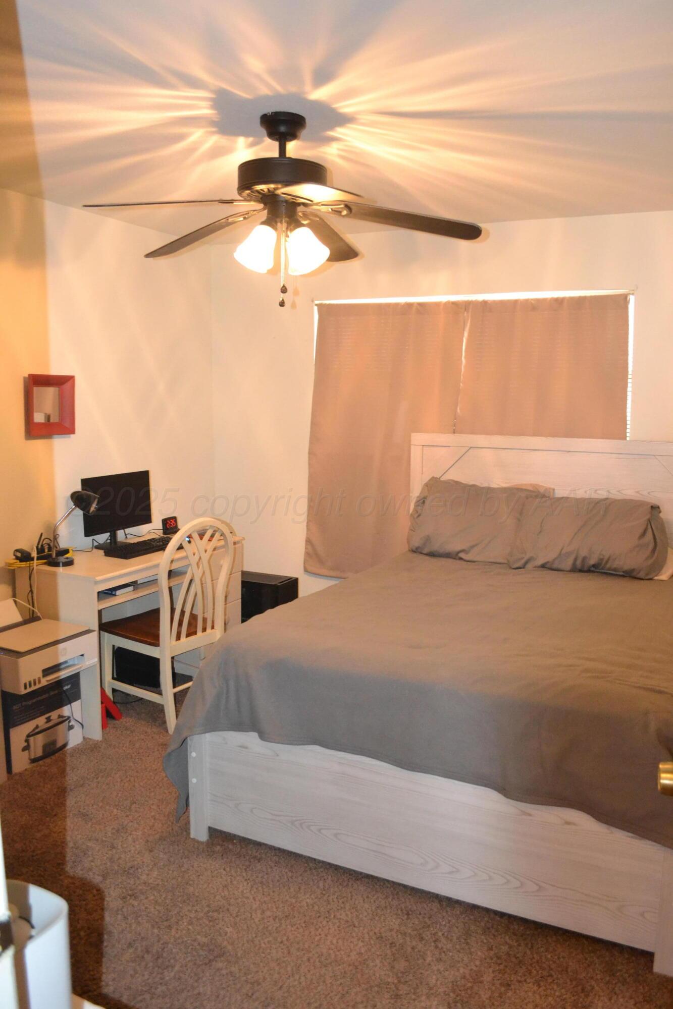 4307-4311 West 2nd Street Plainview, TX 79072 - Photo 10 of 51 a bedroom with a bed and a desk