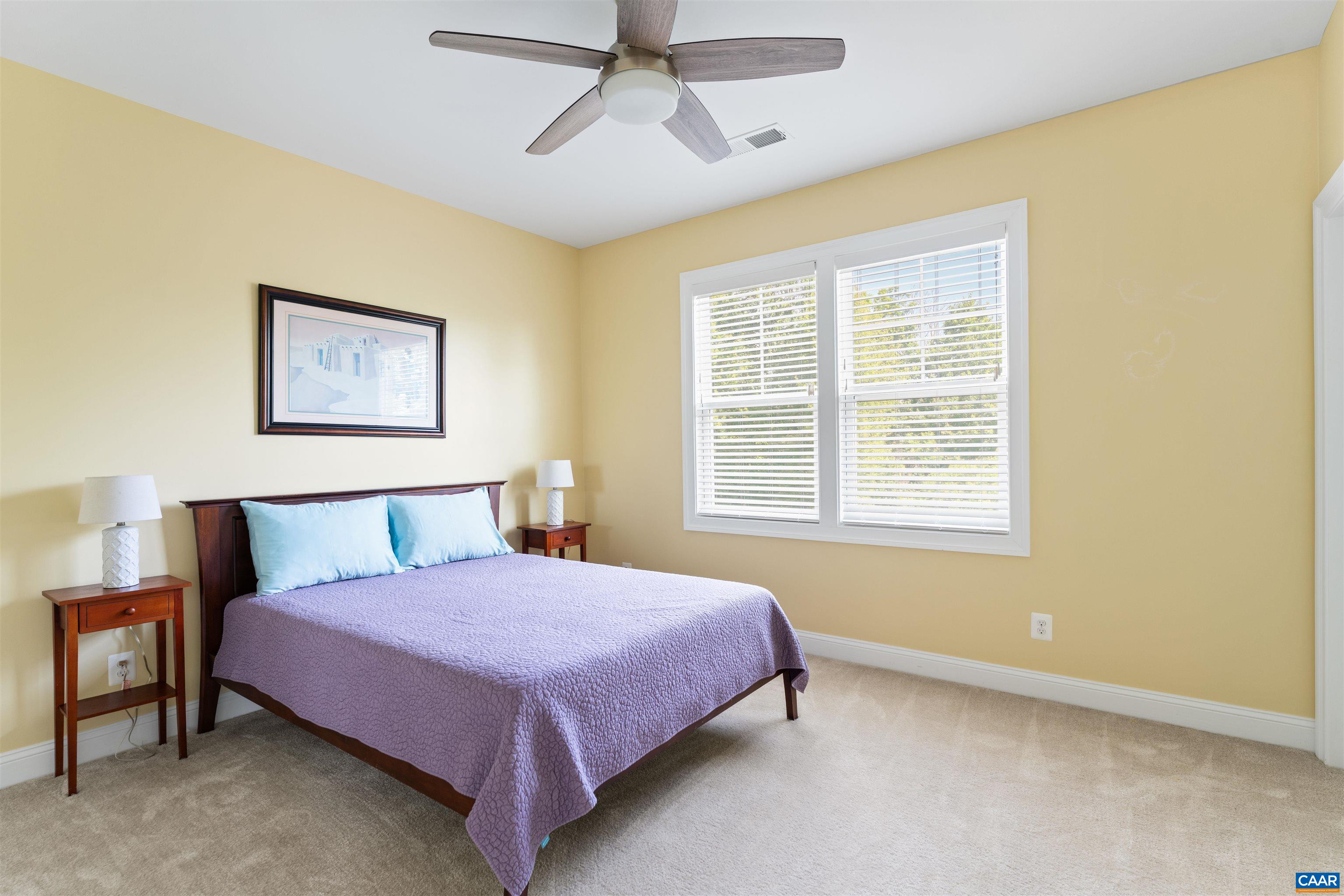 322 Claibourne Road Crozet, VA 22932 - Photo 15 of 25 a spacious bedroom with a bed and a window