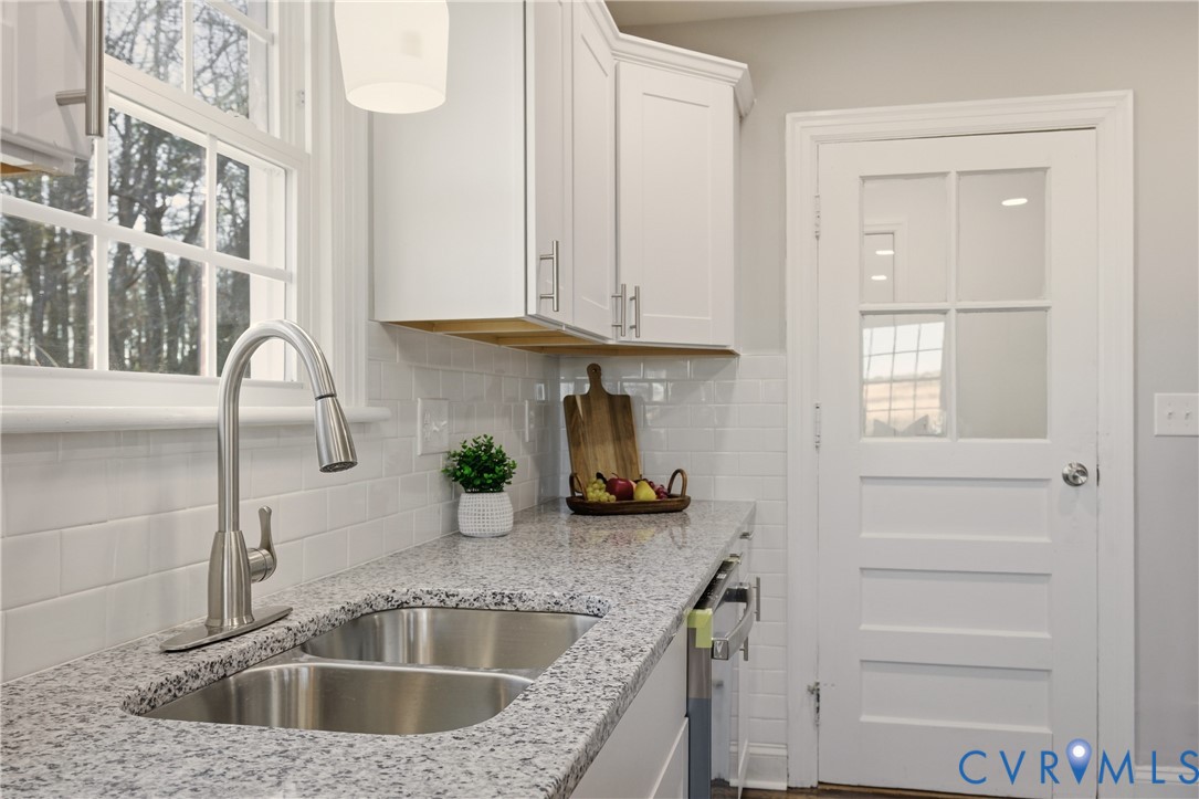 6280 Monahan Road Henrico, VA 23231 - Photo 15 of 42 a kitchen with sink cabinets and a window