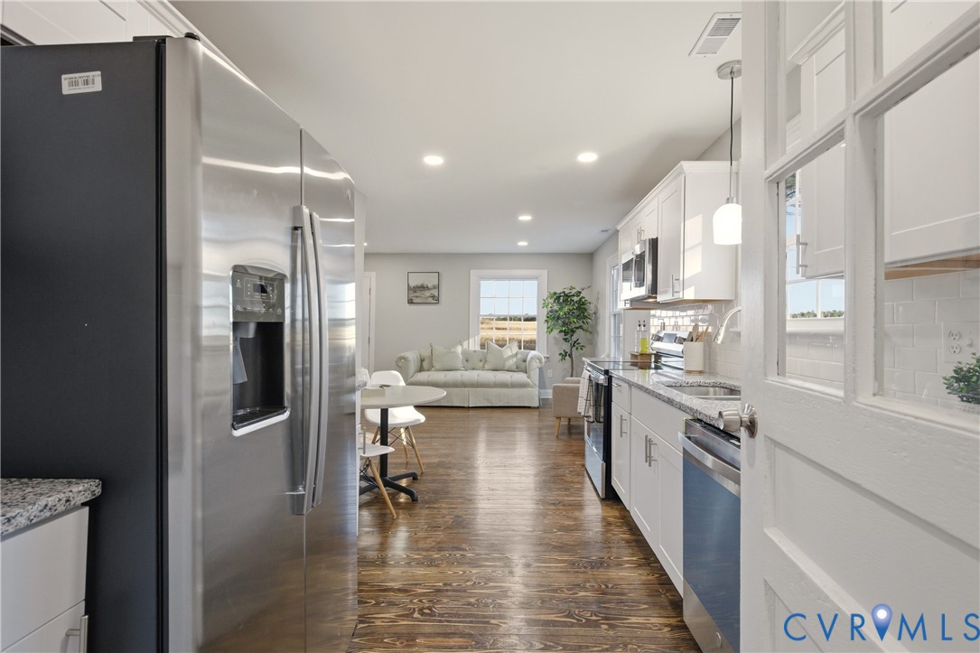 6280 Monahan Road Henrico, VA 23231 - Photo 18 of 42 a kitchen with stainless steel appliances granite countertop a refrigerator a sink dishwasher a stove and white countertops with wooden floor