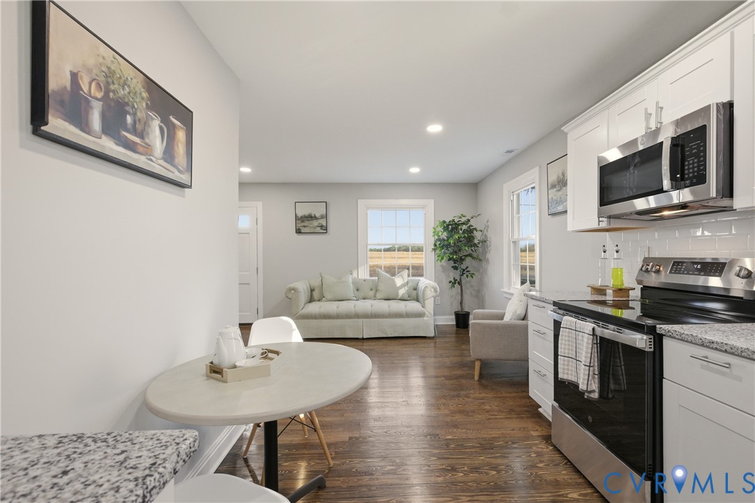 6280 Monahan Road Henrico, VA 23231 - Photo 22 of 42 a living room with furniture a flat screen tv and kitchen view